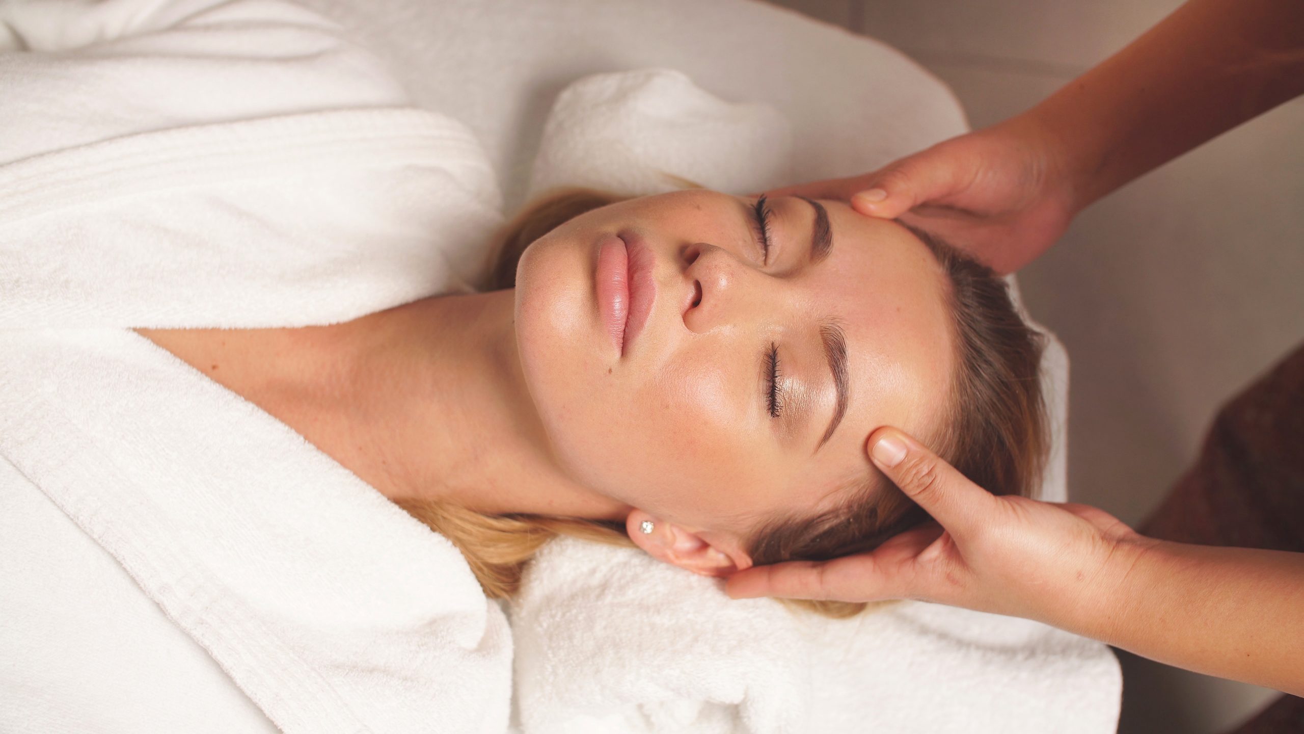 head and face Massage for a beautiful woman in close-up, a woman taking care of her face